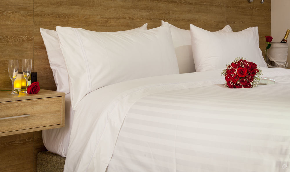 Ghl Collection Barranquilla Hotel Экстерьер фото A bed with white sheets